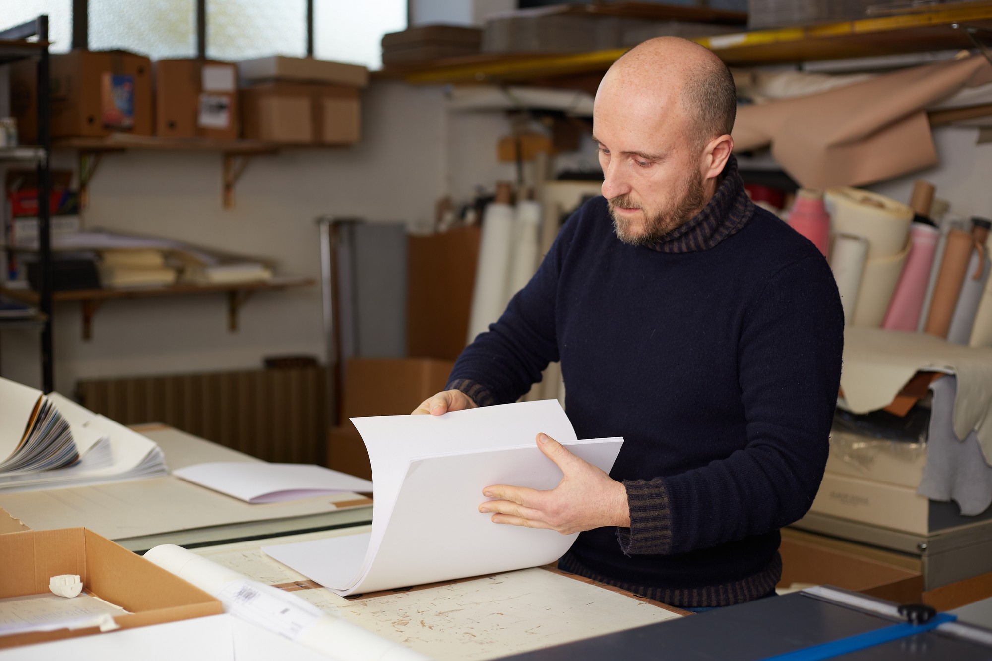 Studio operations manager reviewing order sheets